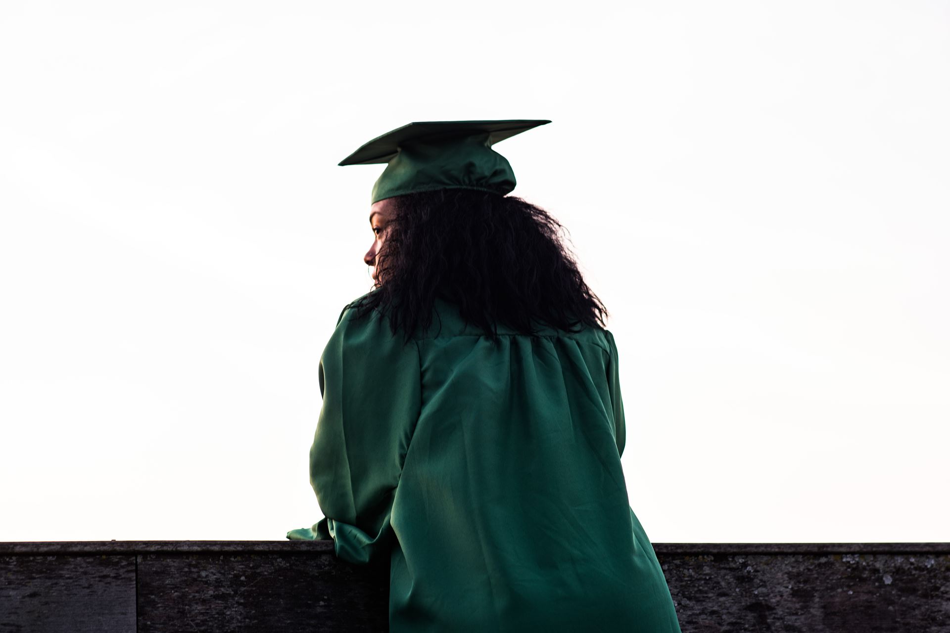 a woman holding a green umbrella