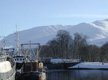 a boat is docked next to a body of water