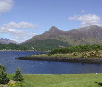 a large body of water with a mountain in the background